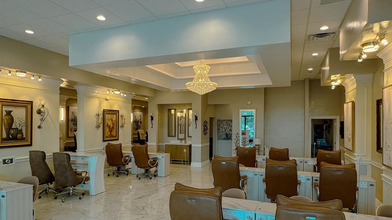 Elegant manicure stations and crystal chandelier at Palace Nail Spa in Midtown Tallahassee